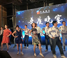A group of EWB China associates on a stage